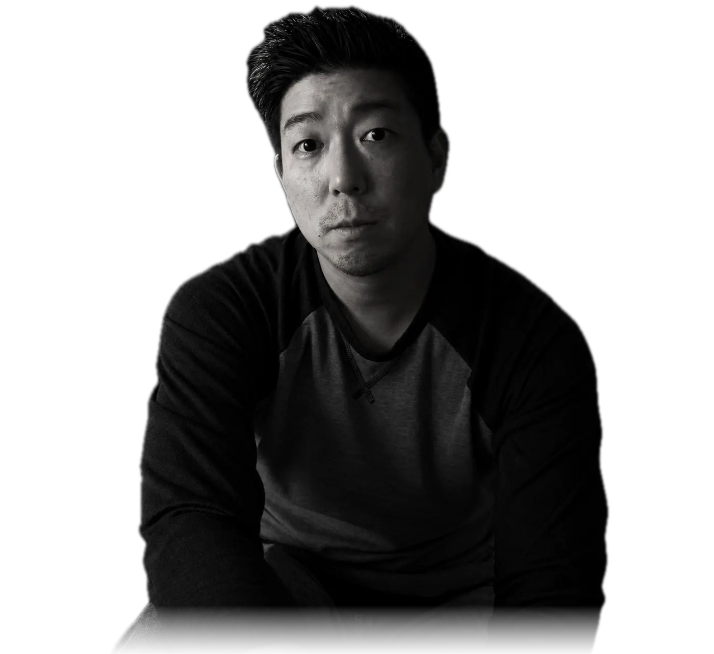 Black-and-white portrait of Daniel Okamura, seated, looking into the camera